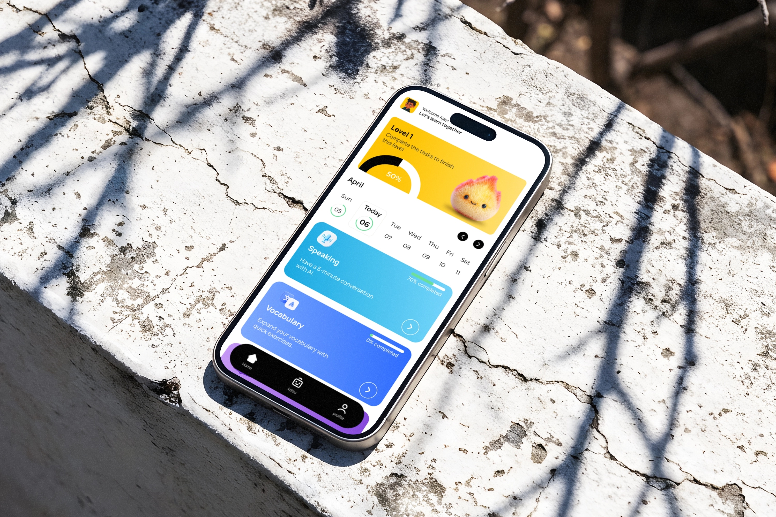 The KDOU app on a phone resting on cracked concrete