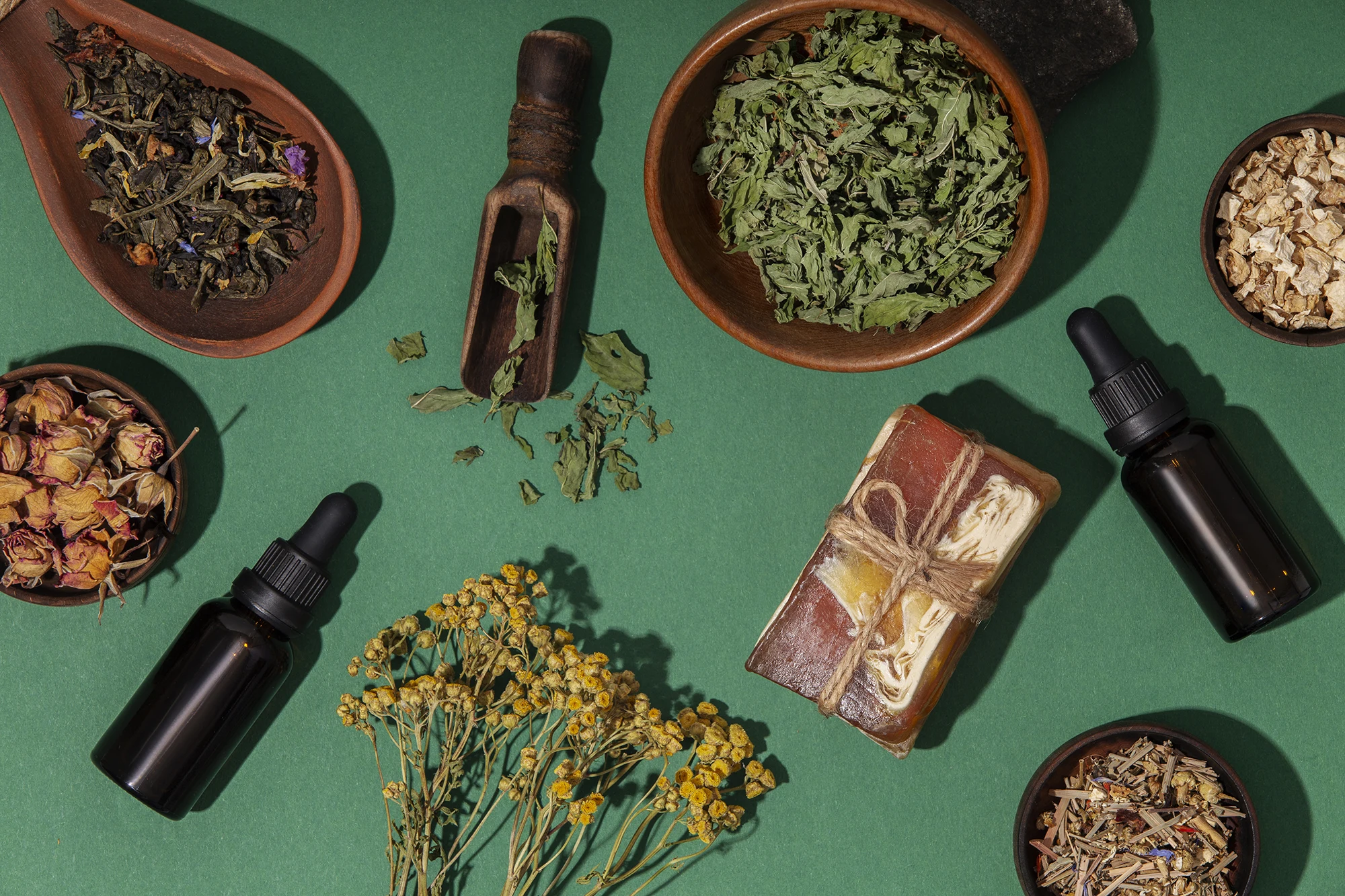 Ayurvedic herbs, powders and oils on green